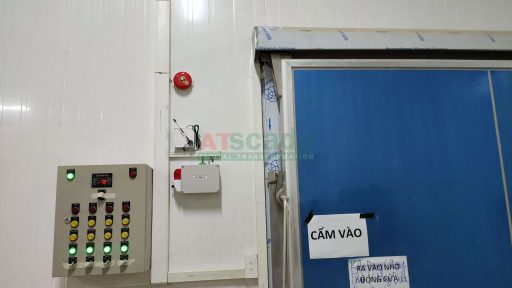 Cold storage control panel installed near insulated door with alarm system and industrial monitoring devices