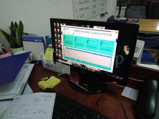 SCADA monitoring workstation displaying industrial control system interface on desktop computer in factory office