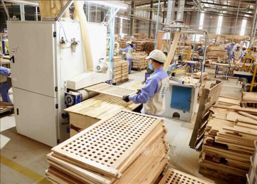wood manufacturing production line with worker operating industrial machinery and automated equipment in furniture factory